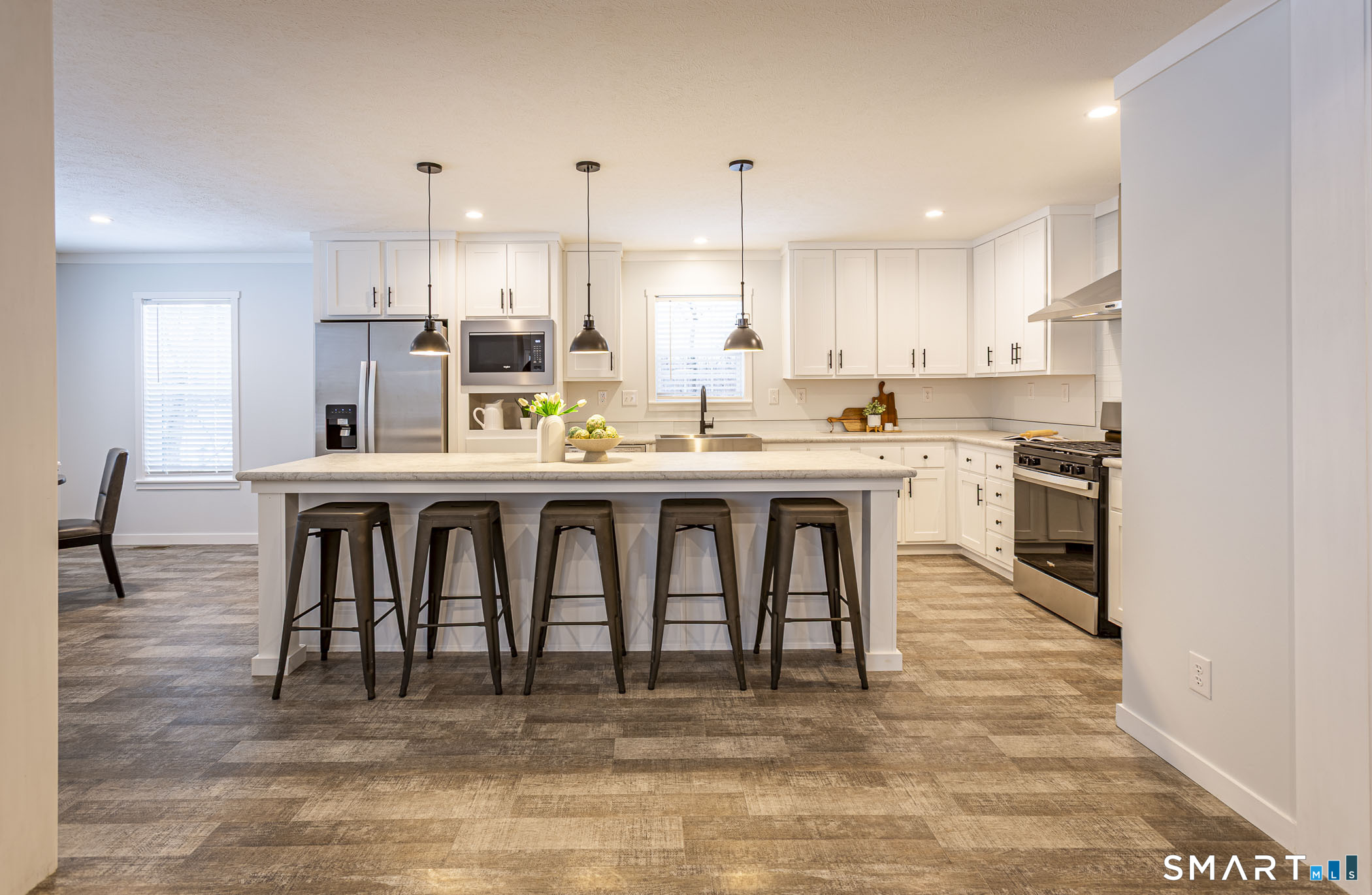 67 Middle Road Enfield, CT 06082 - Photo 6 of 35 a kitchen with stainless steel appliances granite countertop a stove top oven a sink dishwasher and white cabinets