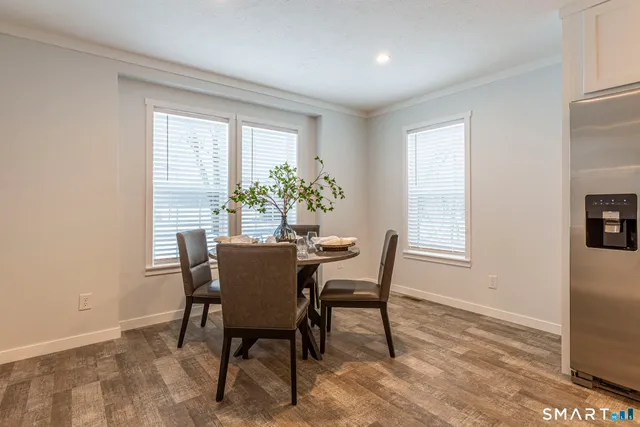 a dining room with furniture and window