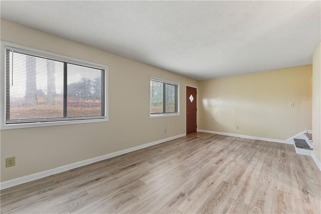 4755 Yates Road, Unit 6D College Park, GA 30337 - Photo 3 of 15 a view of an empty room with wooden floor and a window