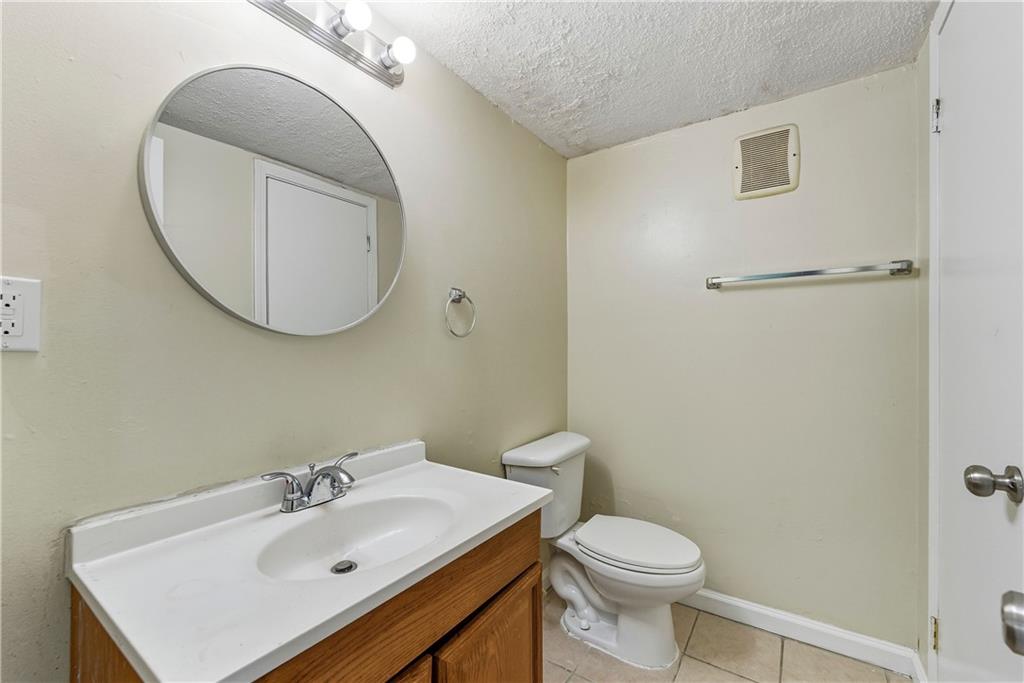4755 Yates Road, Unit 6D College Park, GA 30337 - Photo 4 of 15 a bathroom with a sink a toilet and mirror