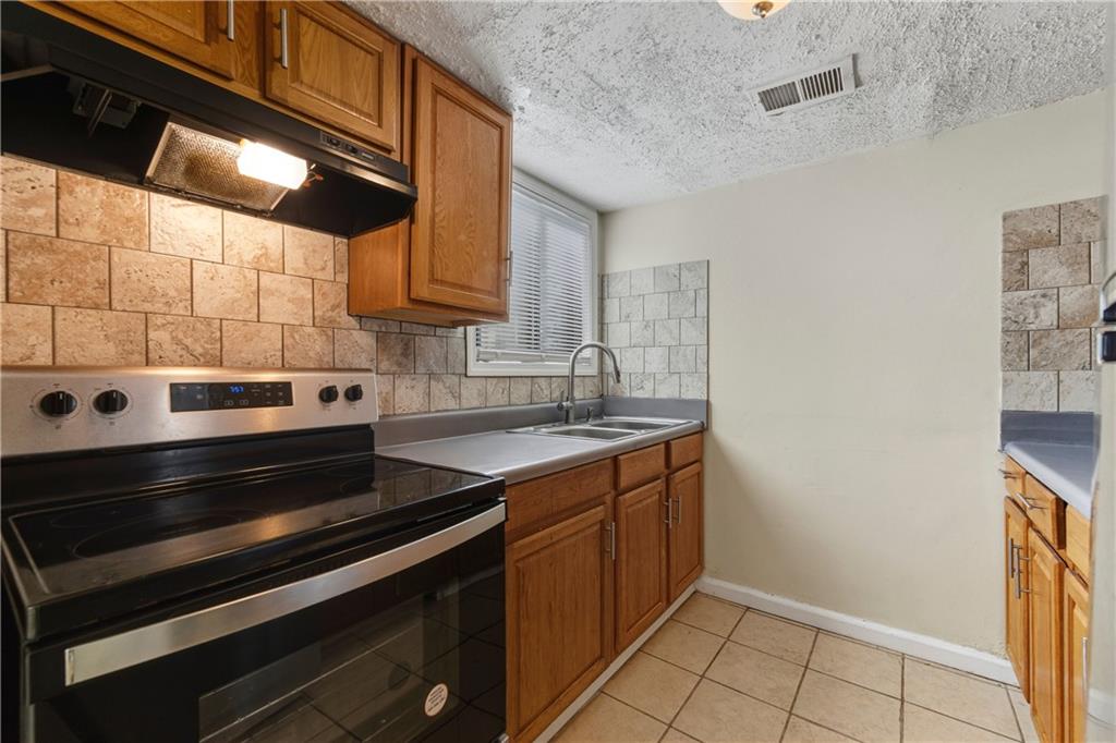 4755 Yates Road, Unit 6D College Park, GA 30337 - Photo 7 of 15 a kitchen with a sink stove and cabinets