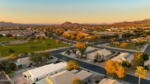 an aerial view of a city with lots of residential buildings and mountain view in back