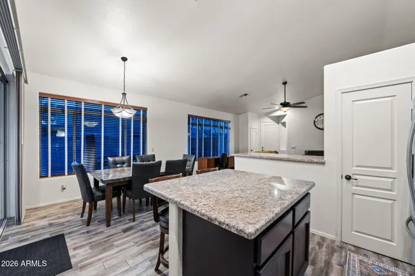 a kitchen with a table chairs and refrigerator