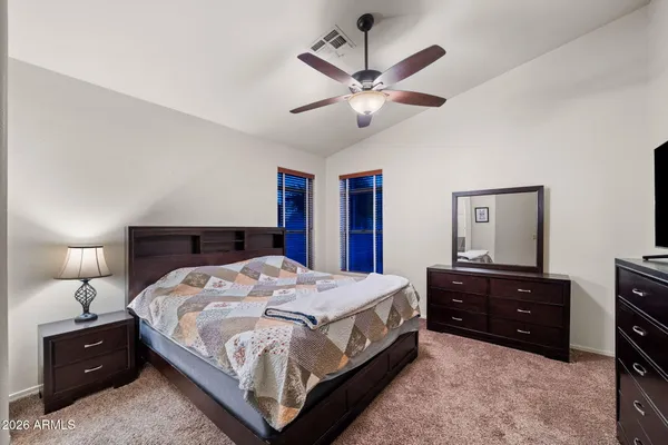 a bedroom with a bed and ceiling fan