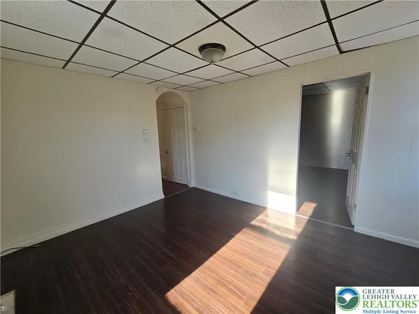 a view of an empty room with wooden floor