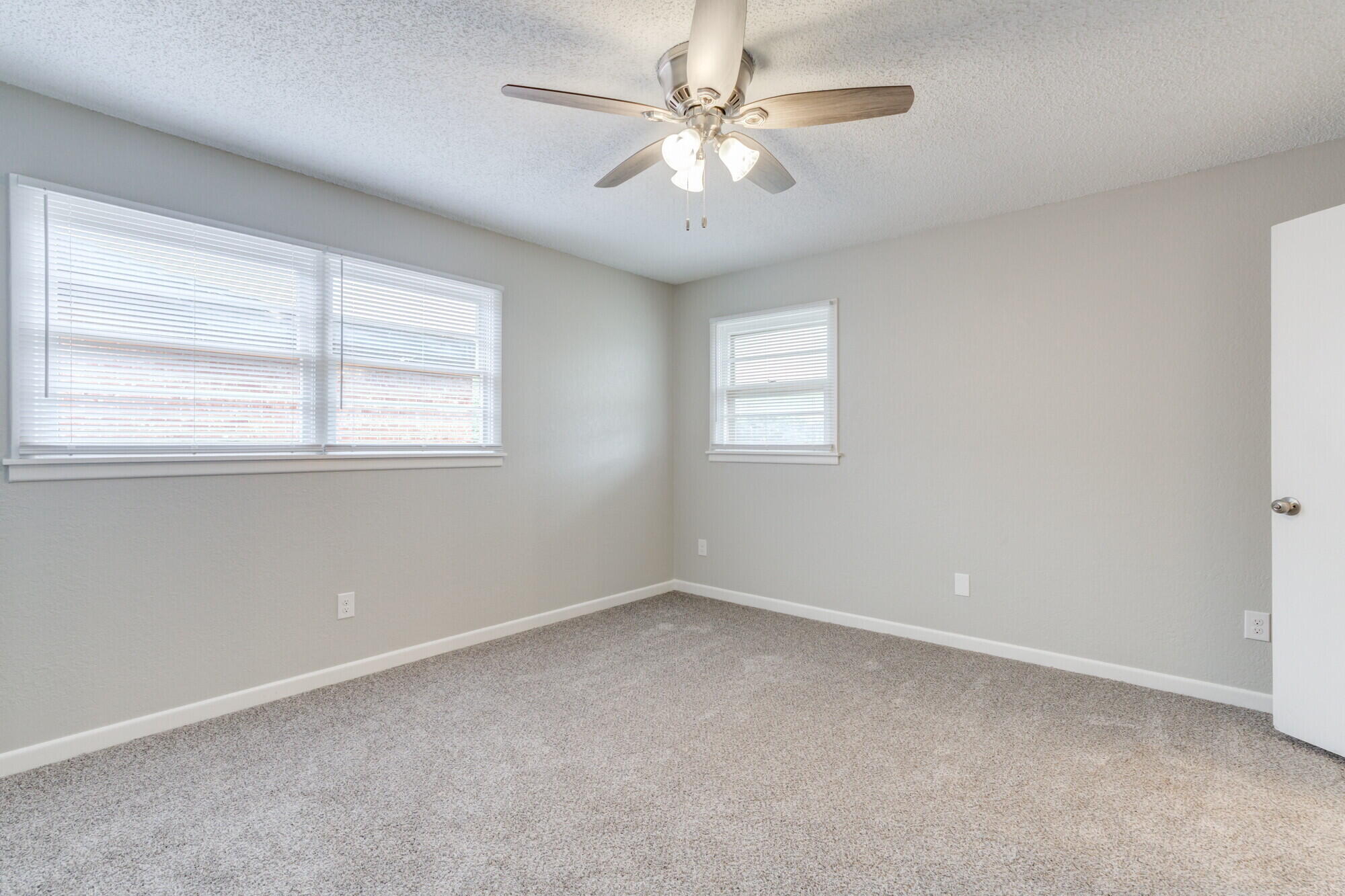 4916 46th Street Lubbock, TX 79414 - Photo 16 of 31 an empty room with a window and a fan