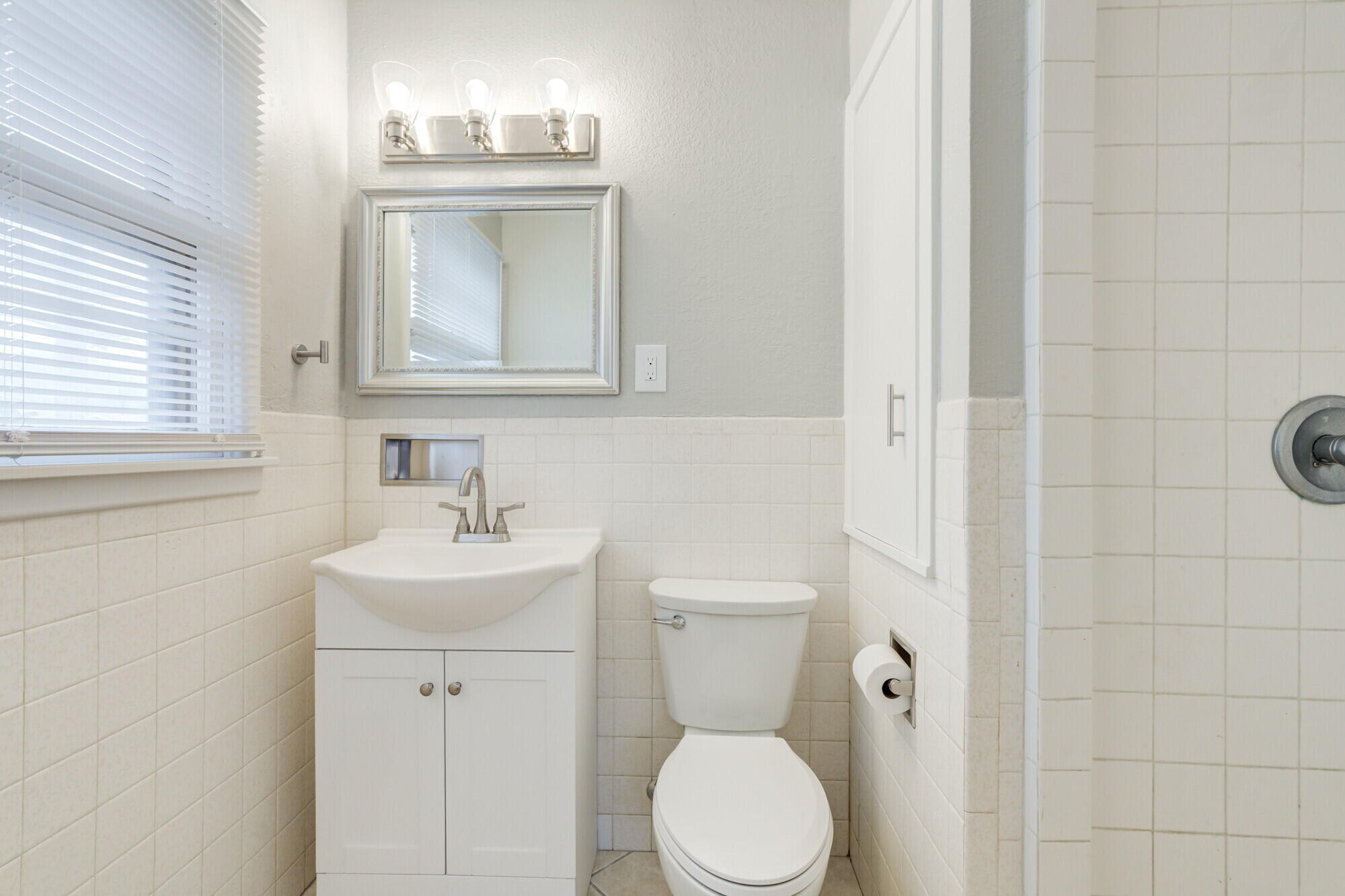 4916 46th Street Lubbock, TX 79414 - Photo 19 of 31 a bathroom with a sink toilet and mirror