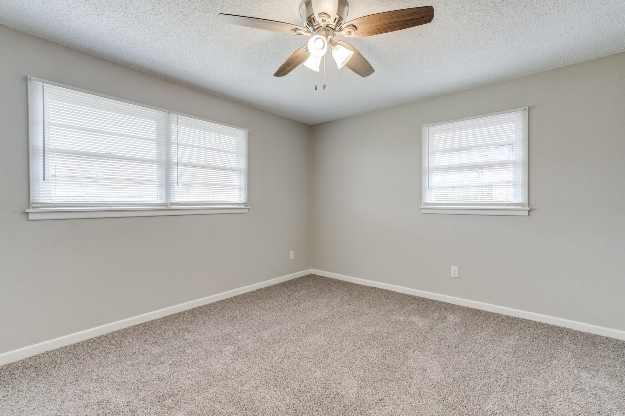 4916 46th Street Lubbock, TX 79414 - Photo 23 of 31 an empty room with a window and a fan