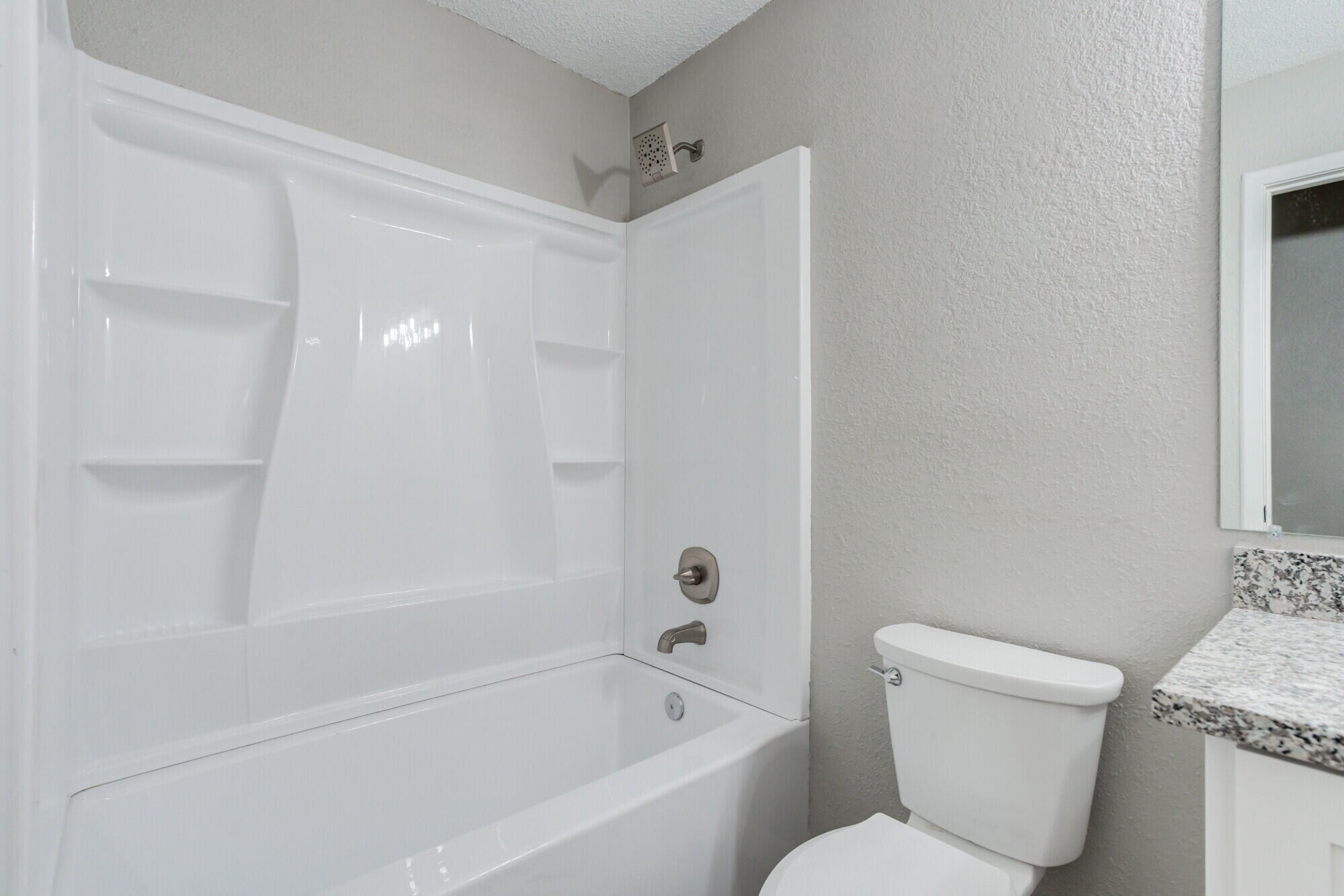 4916 46th Street Lubbock, TX 79414 - Photo 26 of 31 a bathroom with a toilet and a bathtub