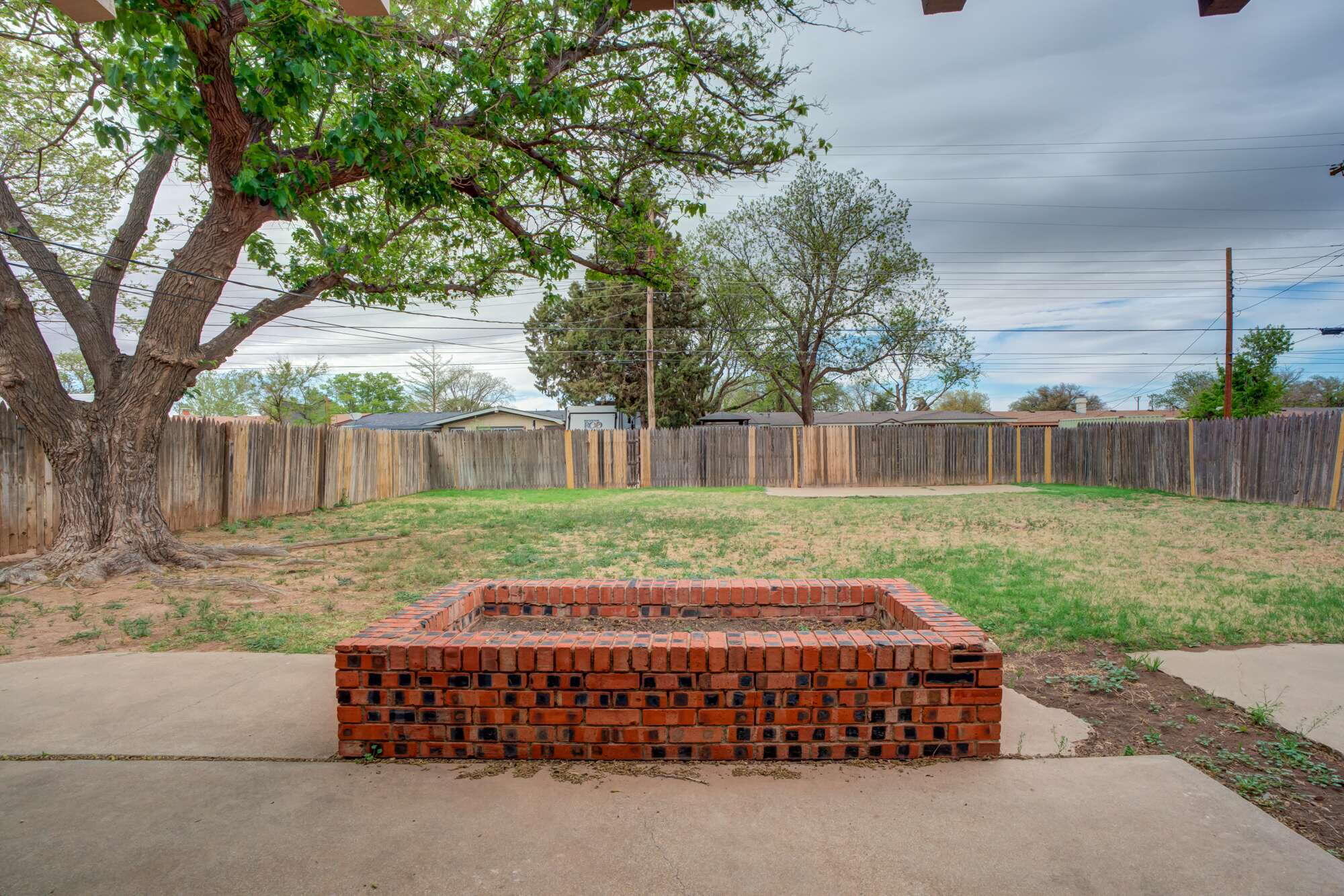 4916 46th Street Lubbock, TX 79414 - Photo 27 of 31 a view of a house with backyard and a tree