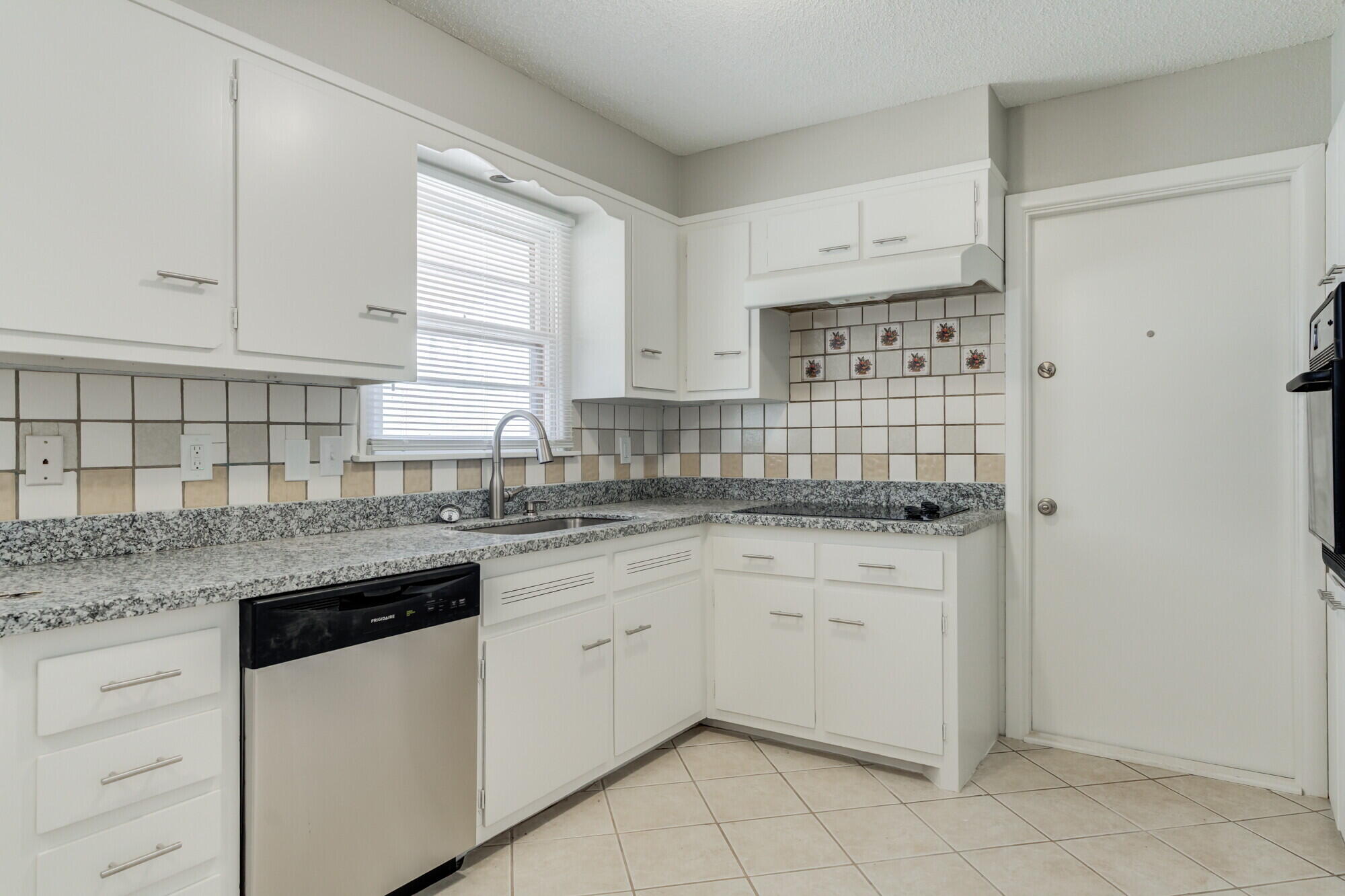 4916 46th Street Lubbock, TX 79414 - Photo 5 of 31 a kitchen with white cabinets appliances a sink and a window
