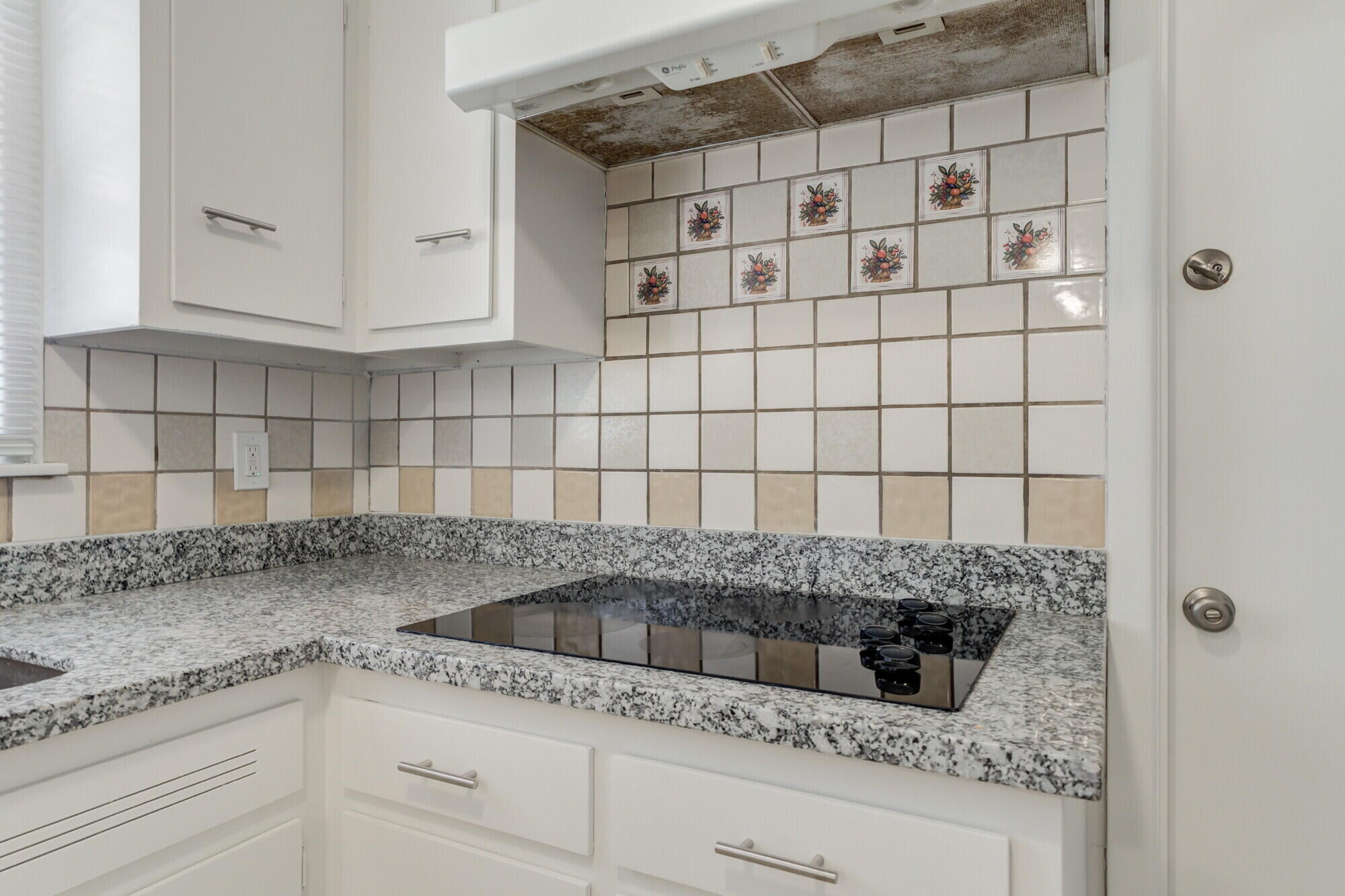 4916 46th Street Lubbock, TX 79414 - Photo 7 of 31 a kitchen with granite countertop white cabinets and a sink