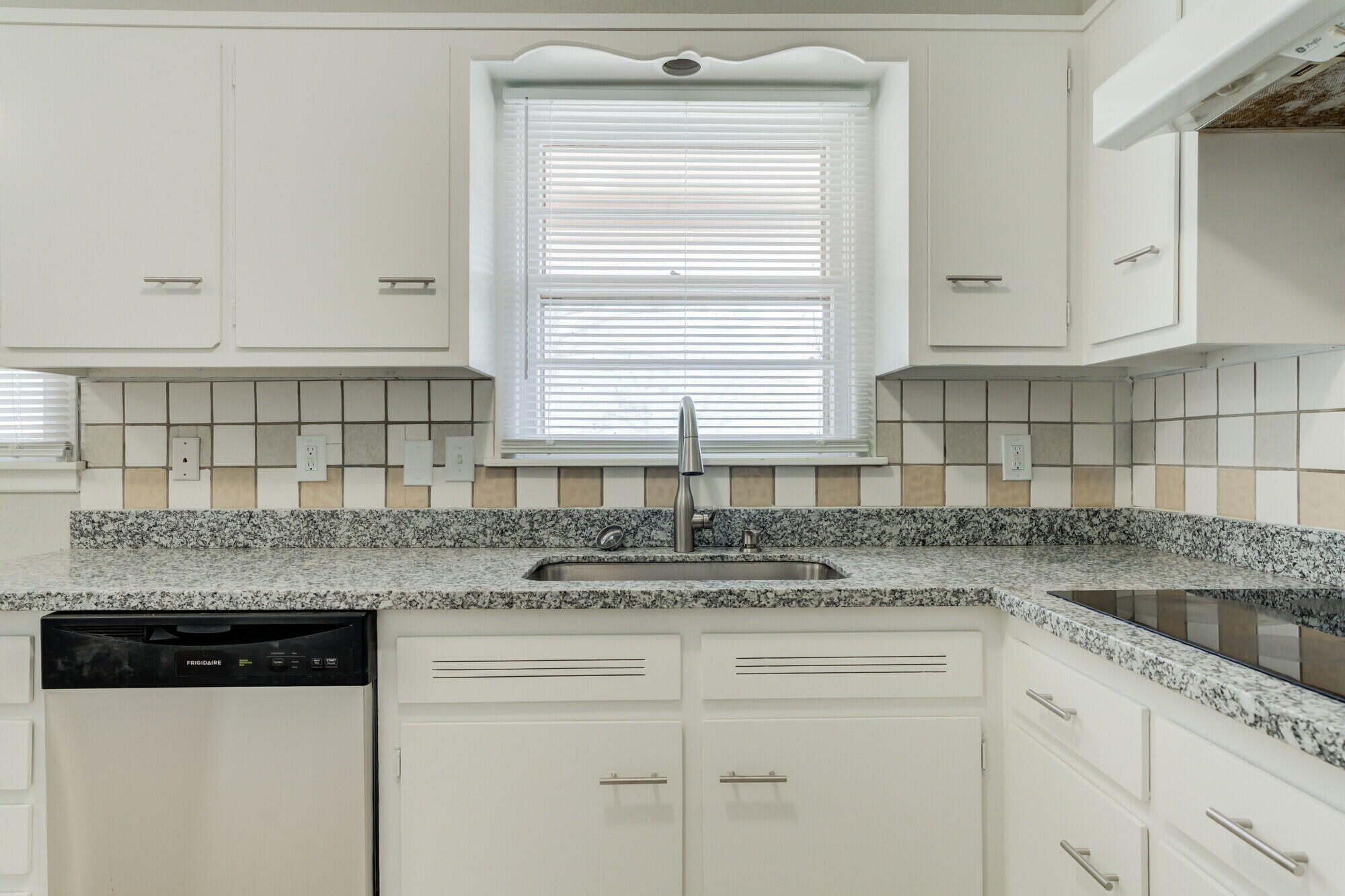 4916 46th Street Lubbock, TX 79414 - Photo 8 of 31 a kitchen with stainless steel appliances granite countertop a sink window and cabinets