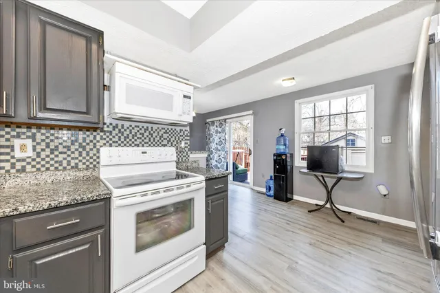 a kitchen with a stove a sink and a refrigerator
