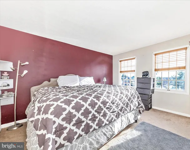 a bedroom with a large bed and a large window