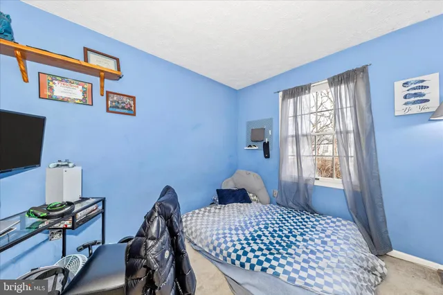 a bedroom with a bed and a desk