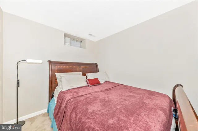 a bedroom with a bed and a mirror