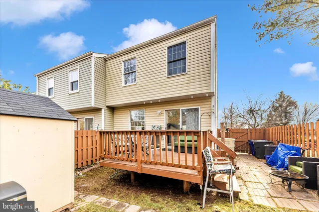 a view of a house with wooden deck and furniture