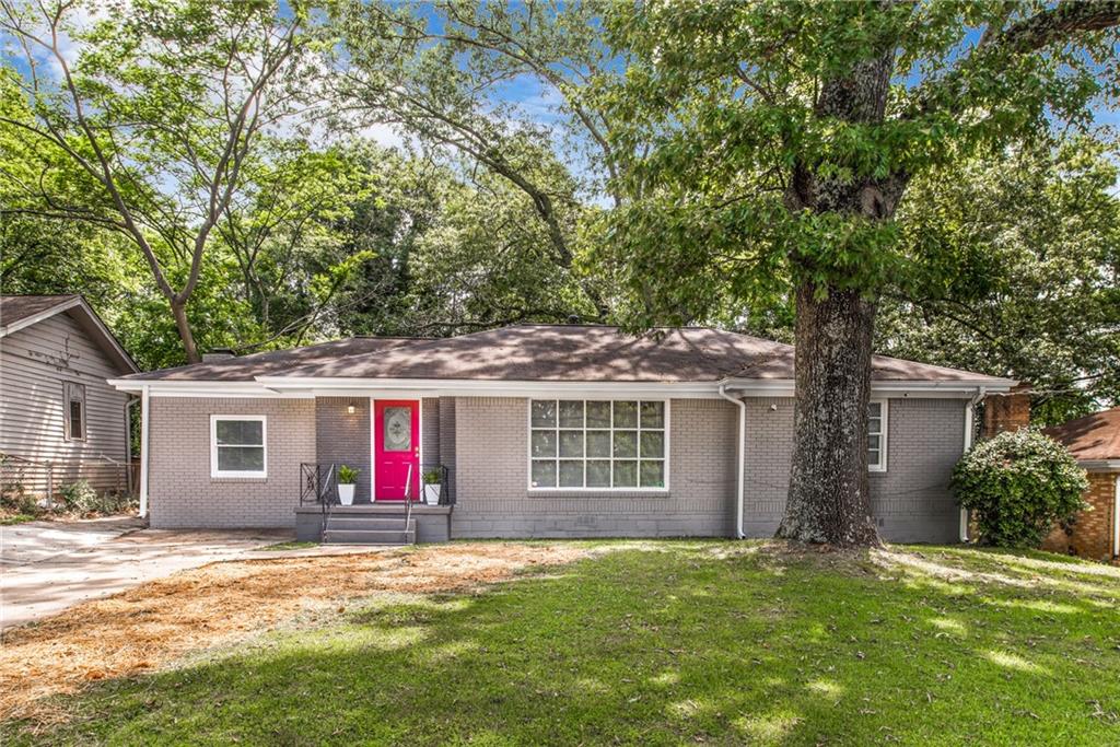 1496 Belva Avenue Decatur, GA 30032 - Photo 1 of 1 a front view of a house with a yard and garage