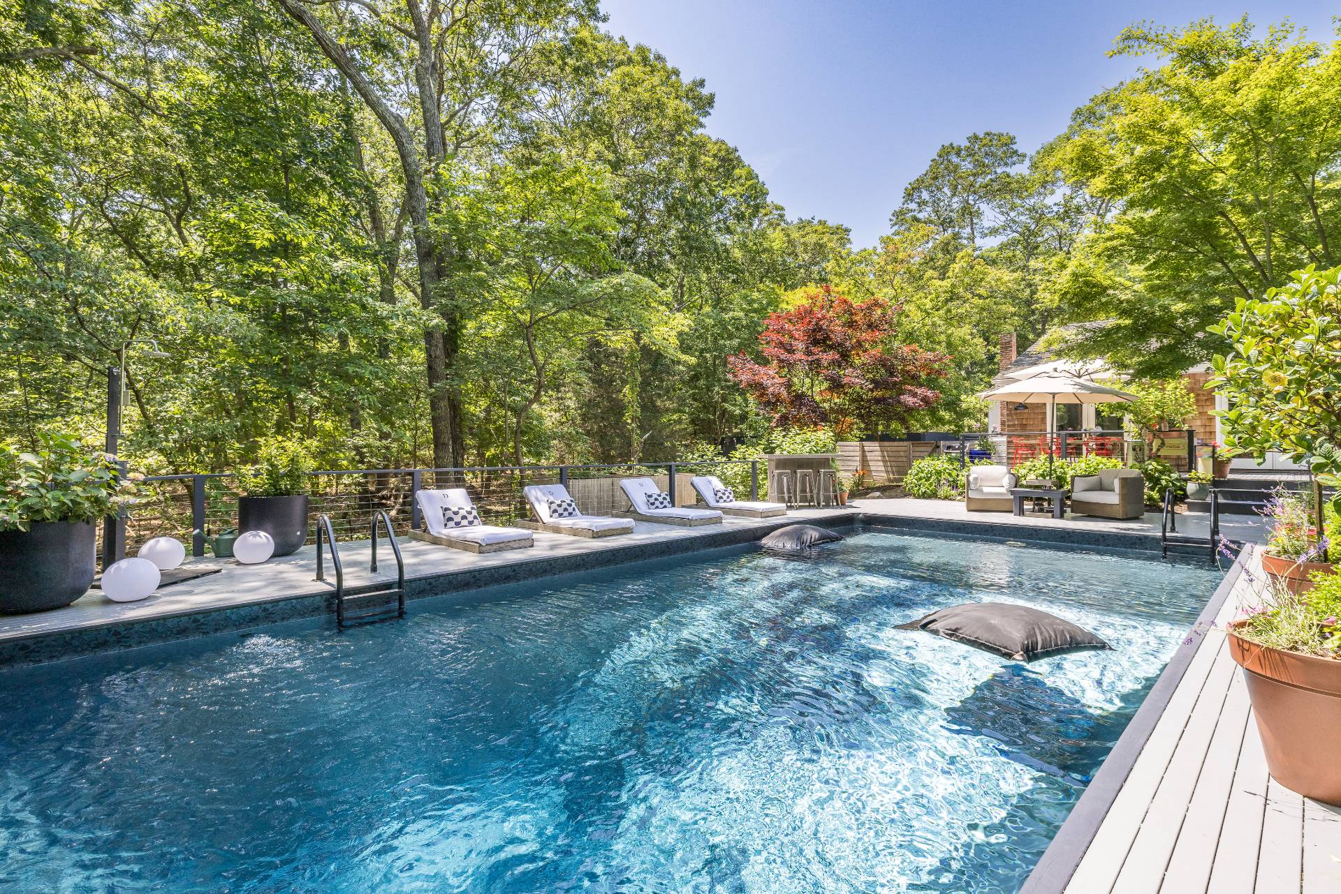 64 Alewife Brook Road East Hampton, NY 11937 - Photo 2 of 26 a view of a swimming pool with a patio
