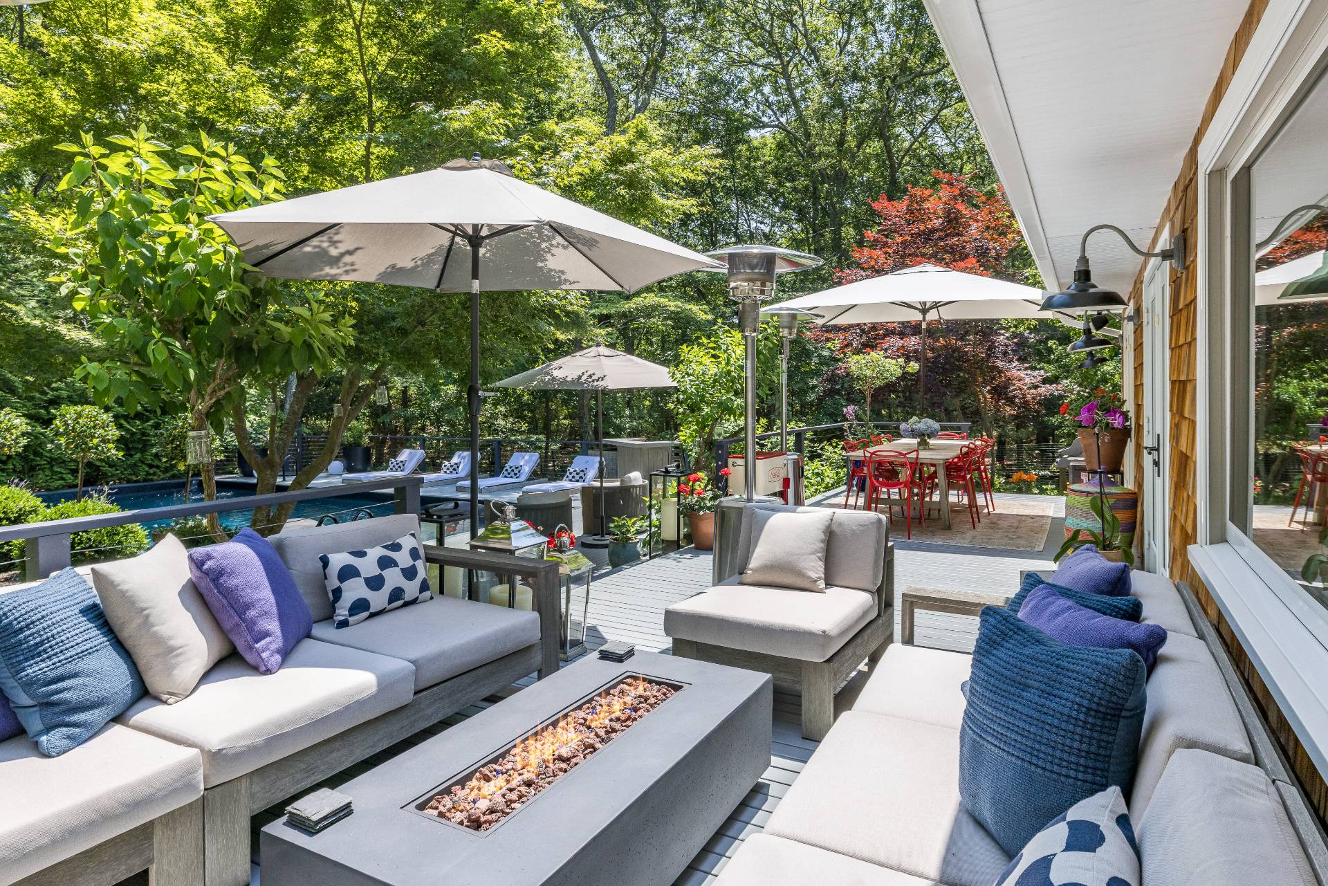 64 Alewife Brook Road East Hampton, NY 11937 - Photo 5 of 26 a patio with patio a table and chairs under an umbrella