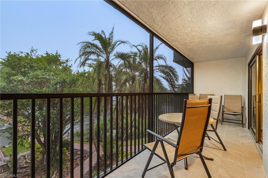 600 Neapolitan Way, Unit 349 Naples, FL 34103 - Photo 1 of 34 a balcony with table and chairs