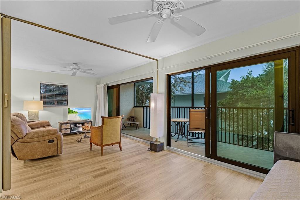 600 Neapolitan Way, Unit 349 Naples, FL 34103 - Photo 15 of 34 a living room with furniture and a large window