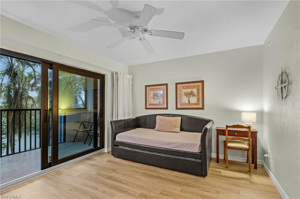 600 Neapolitan Way, Unit 349 Naples, FL 34103 - Photo 16 of 34 a bedroom with a large bed and a chandelier