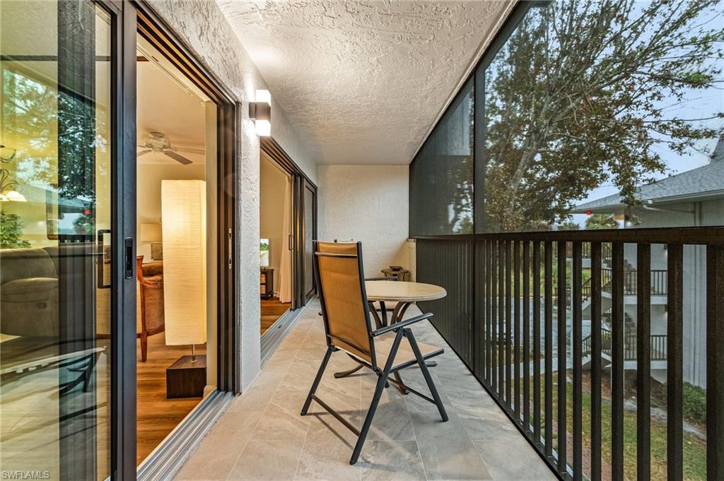 600 Neapolitan Way, Unit 349 Naples, FL 34103 - Photo 17 of 34 a balcony view with a sink and wooden floor