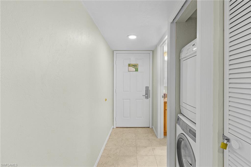 600 Neapolitan Way, Unit 349 Naples, FL 34103 - Photo 2 of 34 a view of a hallway with washer and dryer