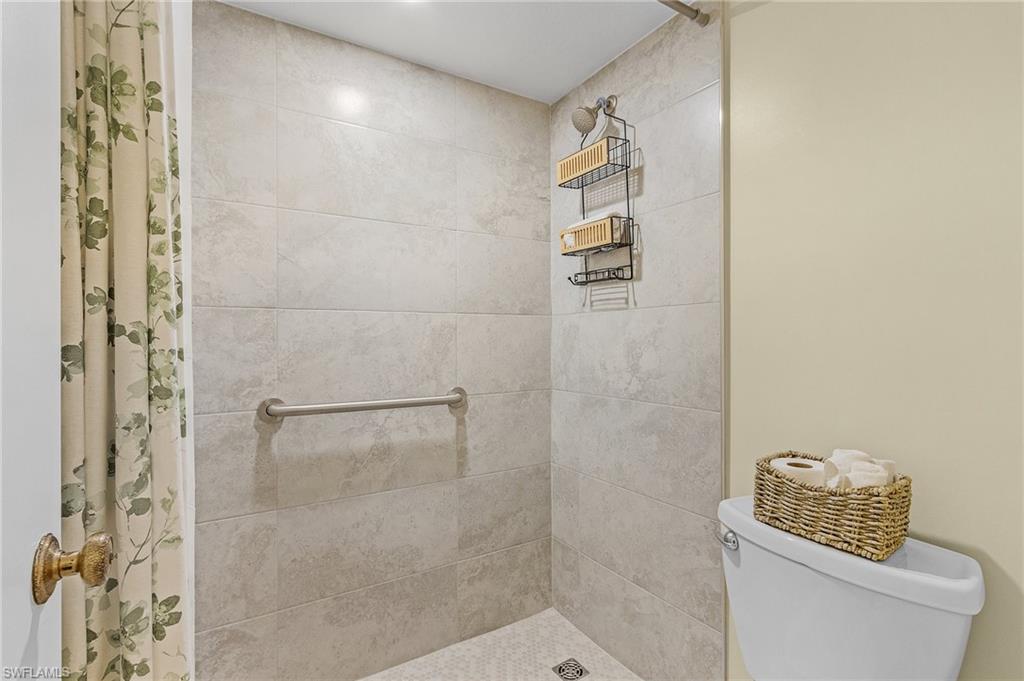 600 Neapolitan Way, Unit 349 Naples, FL 34103 - Photo 22 of 34 a bathroom with a toilet and a shower