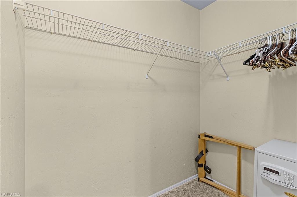 600 Neapolitan Way, Unit 349 Naples, FL 34103 - Photo 23 of 34 a view of a room with racks on the wall