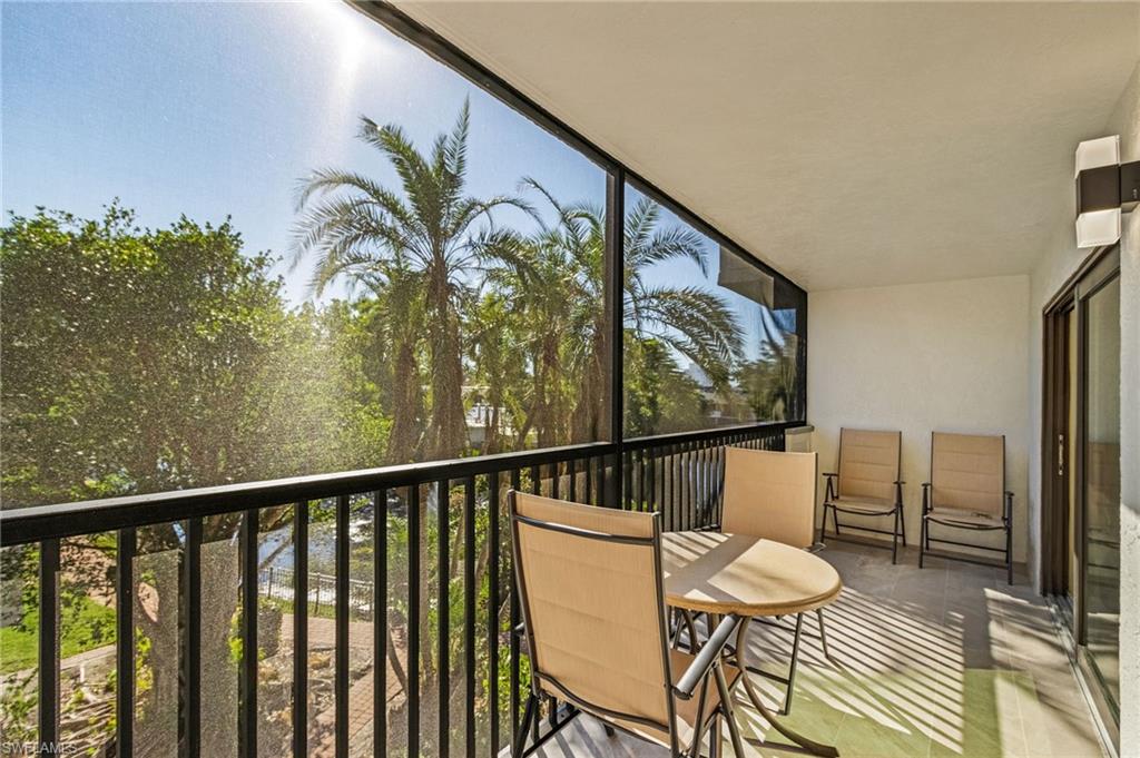 600 Neapolitan Way, Unit 349 Naples, FL 34103 - Photo 25 of 34 a view of a dining room with furniture and wooden floor