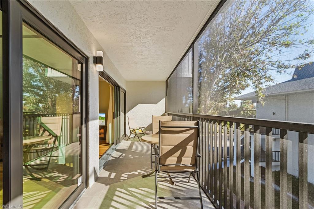 600 Neapolitan Way, Unit 349 Naples, FL 34103 - Photo 26 of 34 a view of balcony with wooden floor