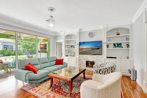 a living room with fireplace furniture and a flat screen tv