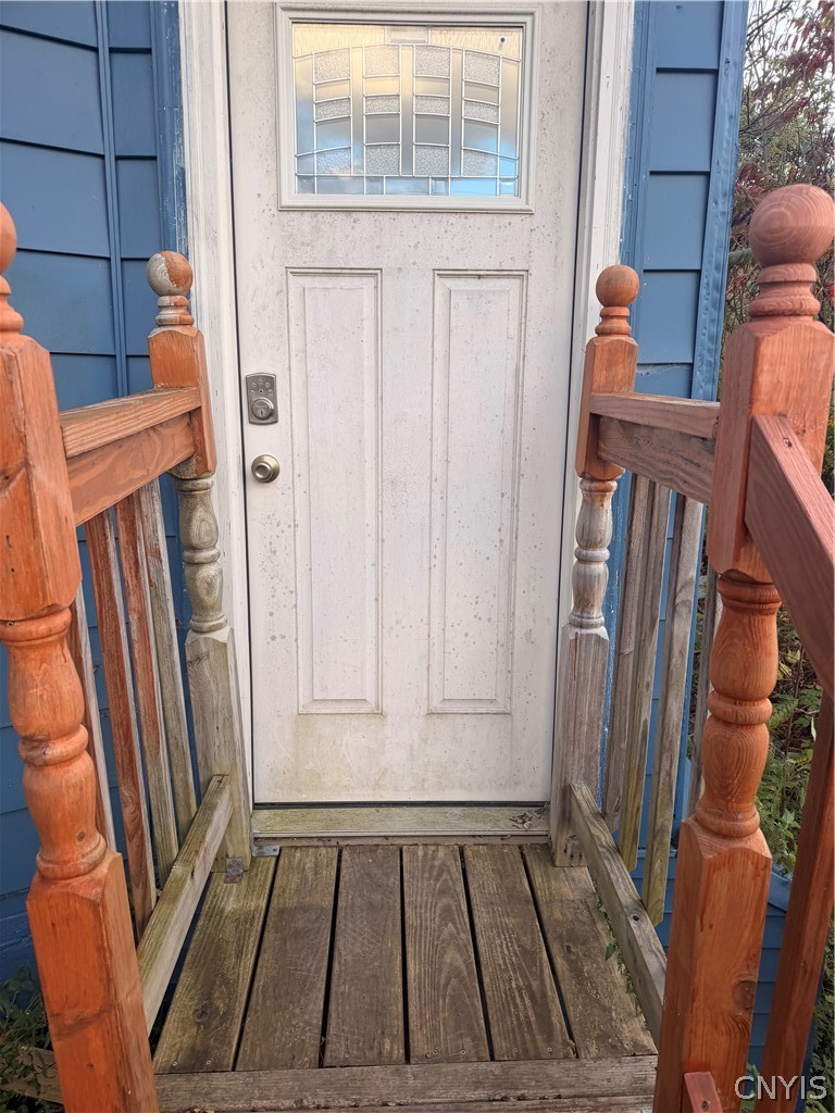 2025 Apulia Road LaFayette, NY 13084 - Photo 11 of 16 A sturdy wooden deck and railing lead directly to the main entryway of this home.