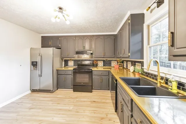 a spacious bedroom with a bed and a chandelier