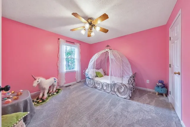 a bed room with a bed and a fan