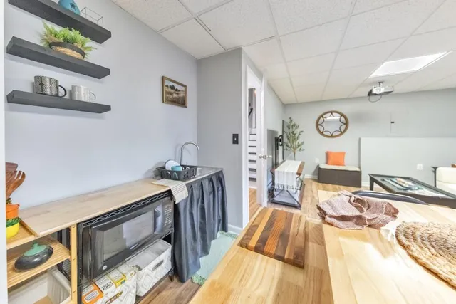 a bathroom with a granite countertop sink a toilet and a mirror
