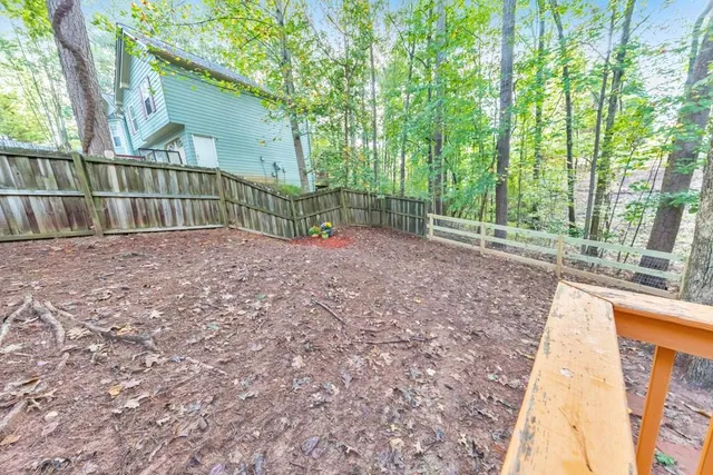 a front view of a house with a tree