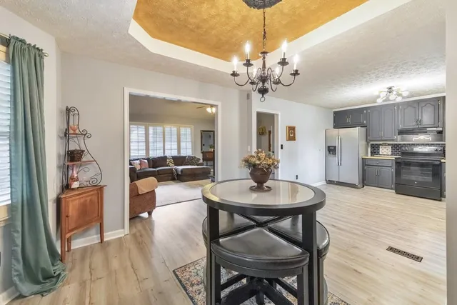 a kitchen with stainless steel appliances granite countertop a refrigerator sink and cabinets