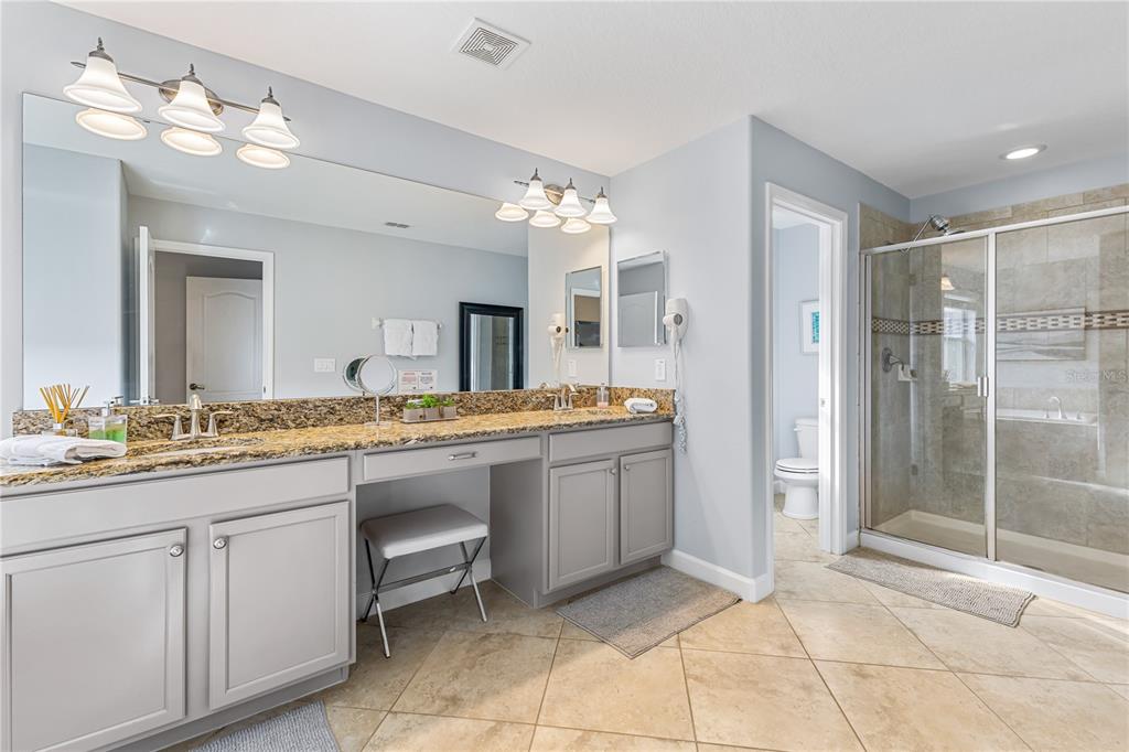 9006 Majesty Palm Road Kissimmee, FL 34747 - Photo 42 of 56 a bathroom with a sink and a mirror
