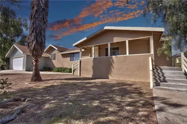 a house with trees in the background