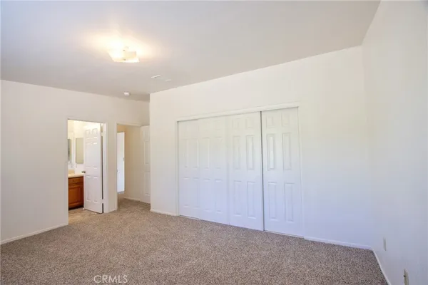 an empty room with a window and a mirror