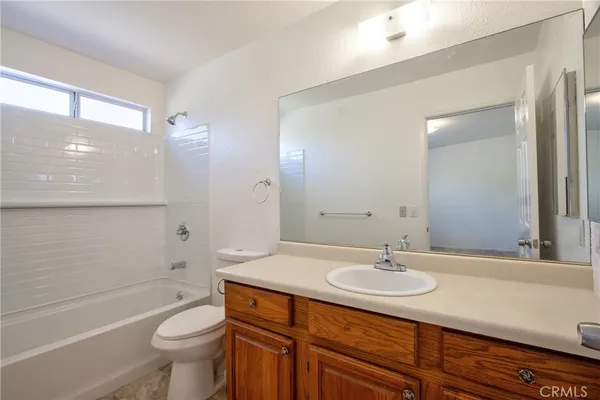 a bath tub sitting next to a white toilet and a shower