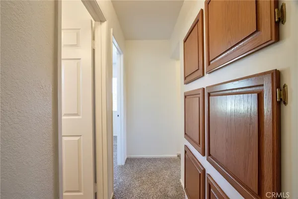 an empty room with closet and windows