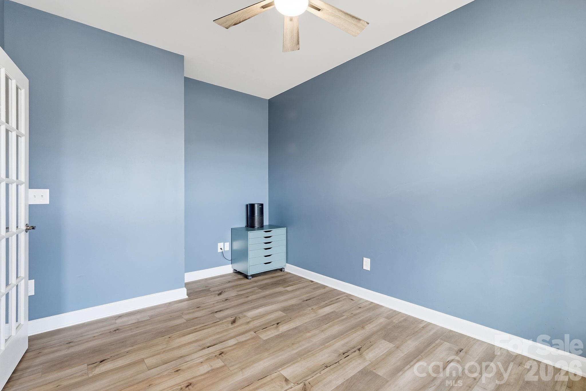 3911 Horsham Street Fort Mill, SC 29707 - Photo 18 of 41 a view of a room with wooden floor and a ceiling fan