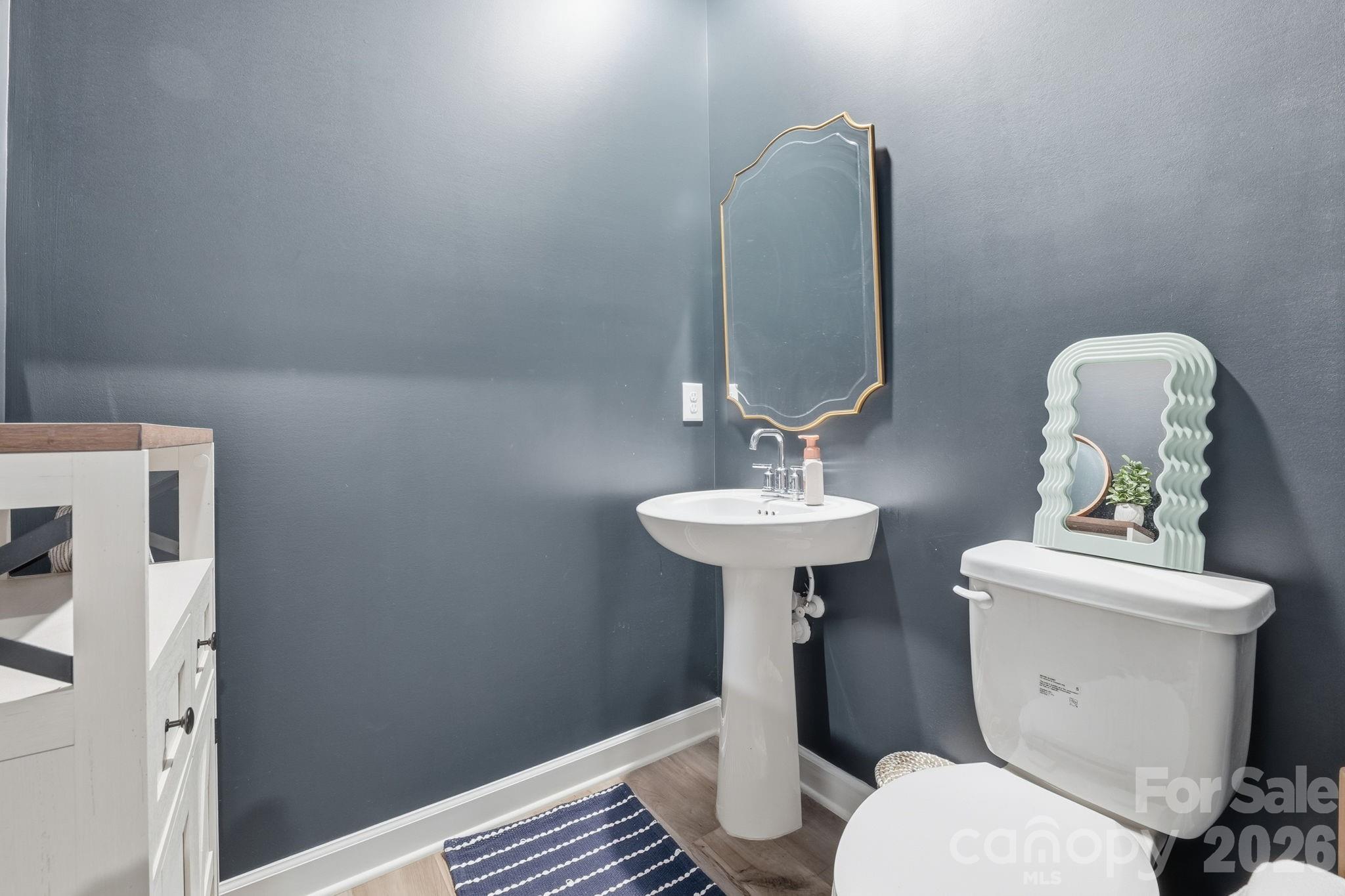 3911 Horsham Street Fort Mill, SC 29707 - Photo 19 of 41 a bathroom with a toilet sink and mirror