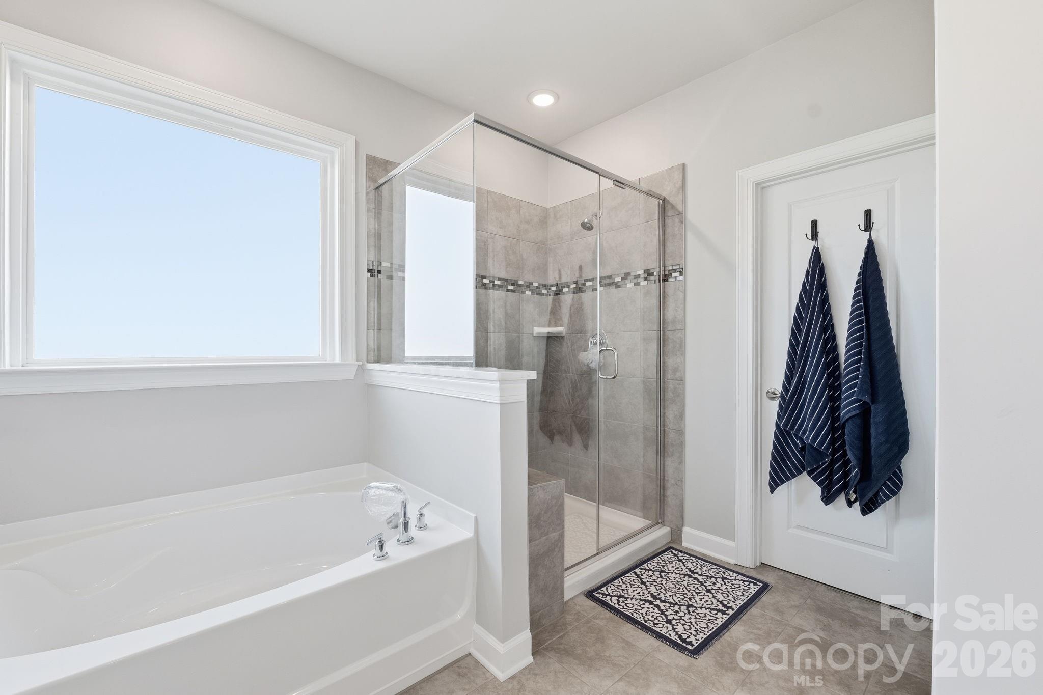 3911 Horsham Street Fort Mill, SC 29707 - Photo 5 of 41 a bathroom with a bathtub and a shower