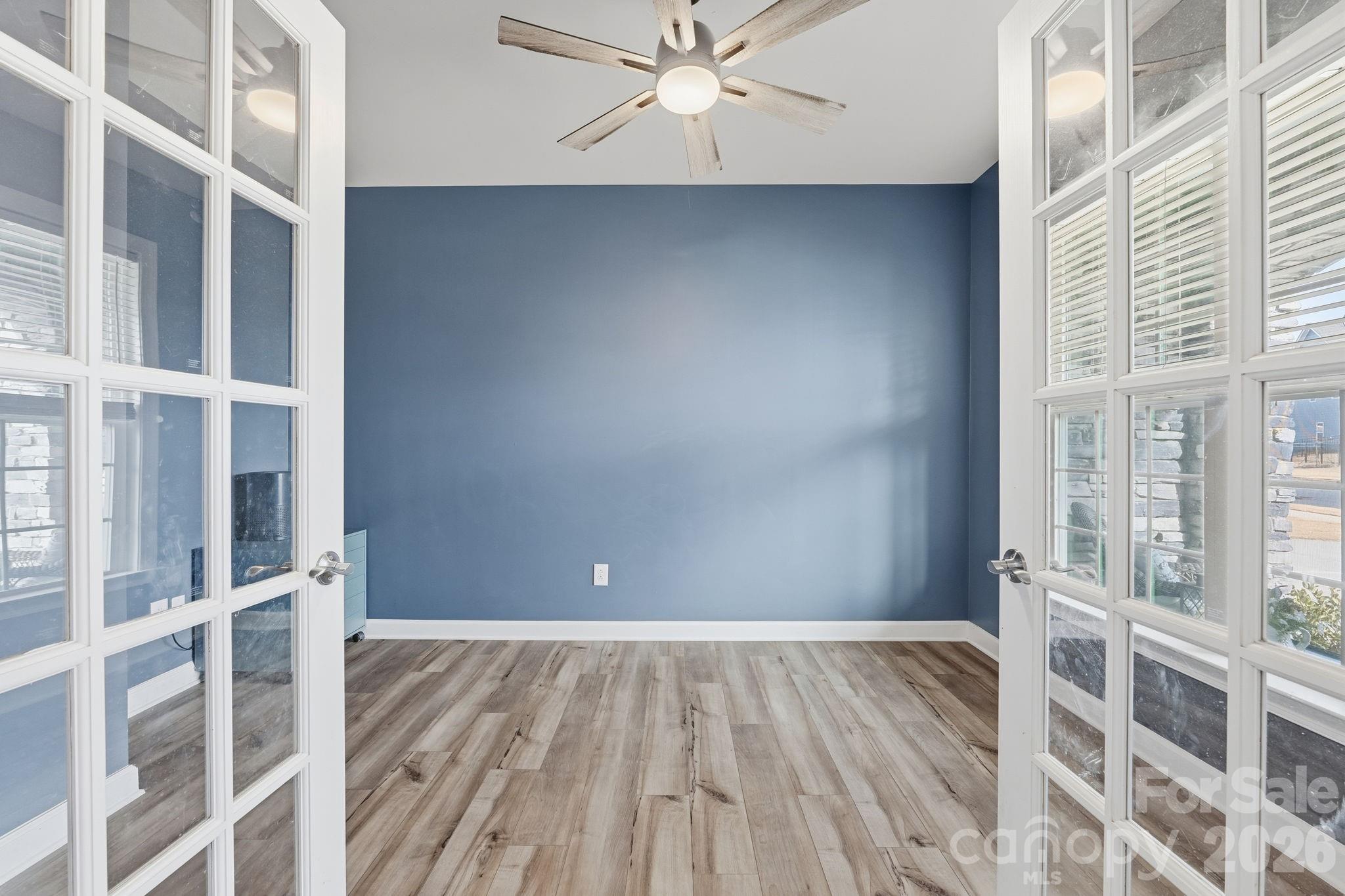 3911 Horsham Street Fort Mill, SC 29707 - Photo 9 of 41 a view of an empty room with wooden floor and a window